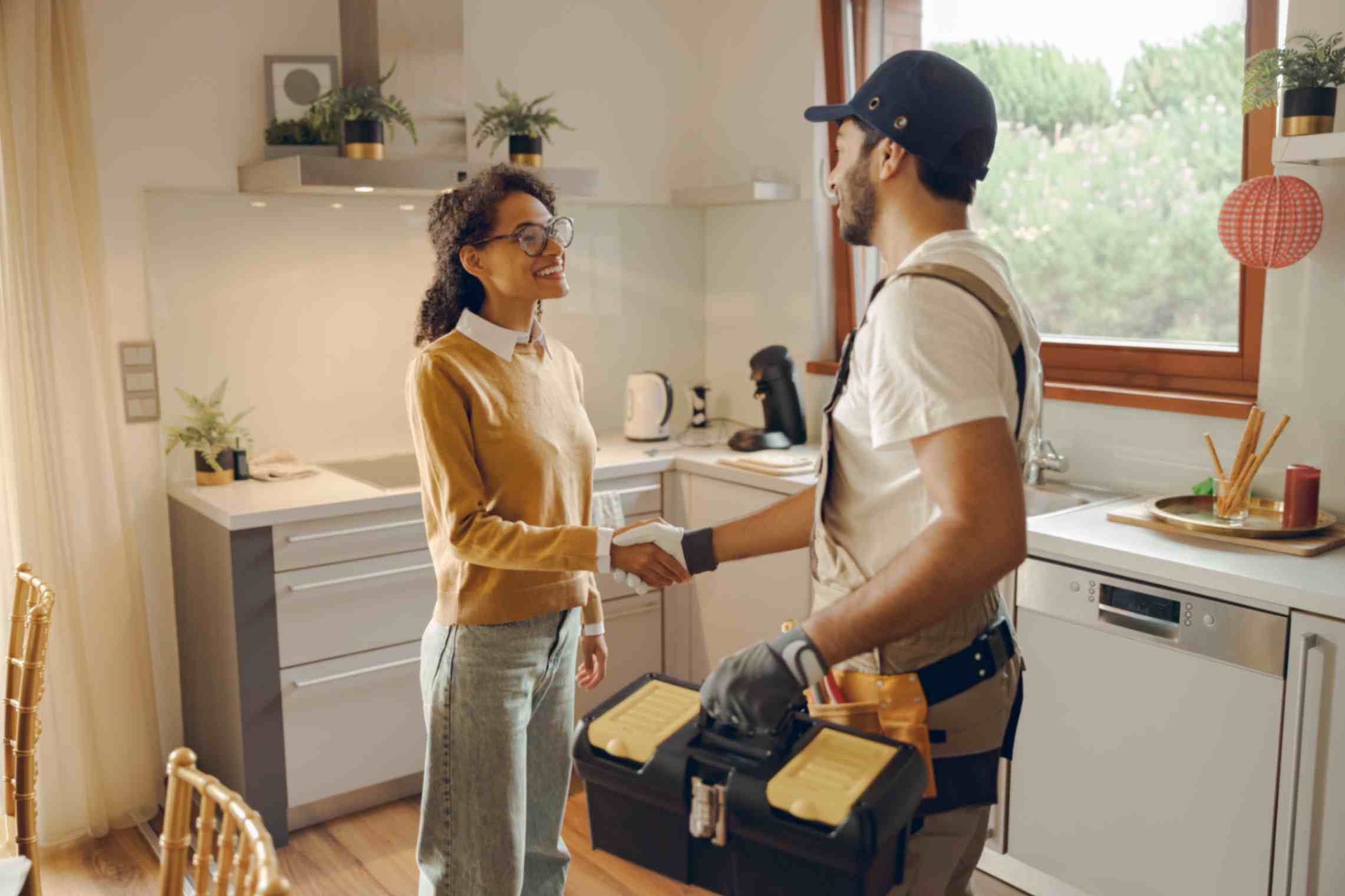 professional repairman uniform shaking hands woman