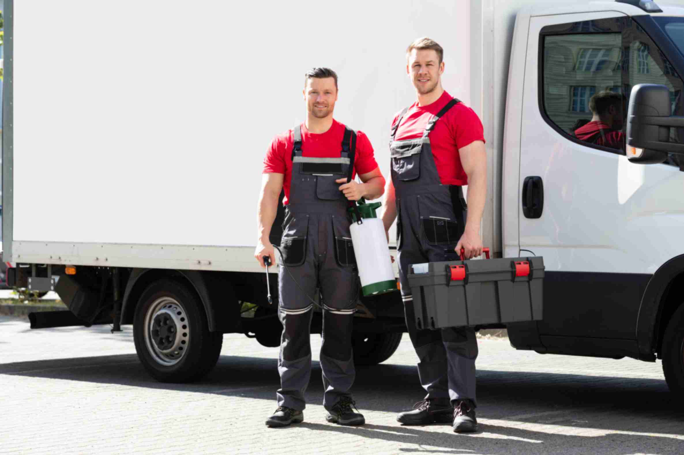 technicians standing against truck