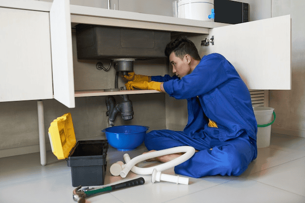 A plumber is checking the drain